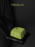 Load image into Gallery viewer, Hero image of A Letter from Wind, an architecture-inspired matcha yuzu mousse cake.