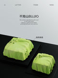 Load image into Gallery viewer, Overview of A Letter from Wind matcha yuzu mousse cakes in a minimalist studio setting.