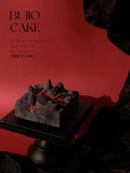 Load image into Gallery viewer, Fire of Love mousse cake displayed on a pedestal with a red editorial background.