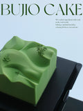 Load image into Gallery viewer, Editorial presentation of Mountain Wind jasmine green grape mousse cake.