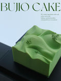 Load image into Gallery viewer, Overview of Mountain Wind mousse cake in a minimalist studio setting.