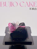 Load image into Gallery viewer, Overview of Self Love lychee rose mousse cake in a minimalist studio setting.