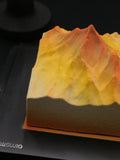 Load image into Gallery viewer, Detailed sculptural mountain texture of Up to the Radiance Earl Grey caramel apple mousse cake.